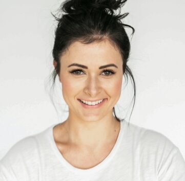 woman in white crew neck shirt smiling