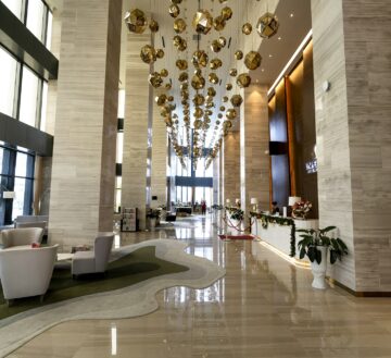 a hotel lobby with a chandelier hanging from the ceiling