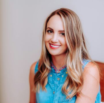 smiling girl in blue sleeveless dress
