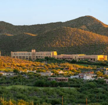 A scenic view of a city surrounded by mountains